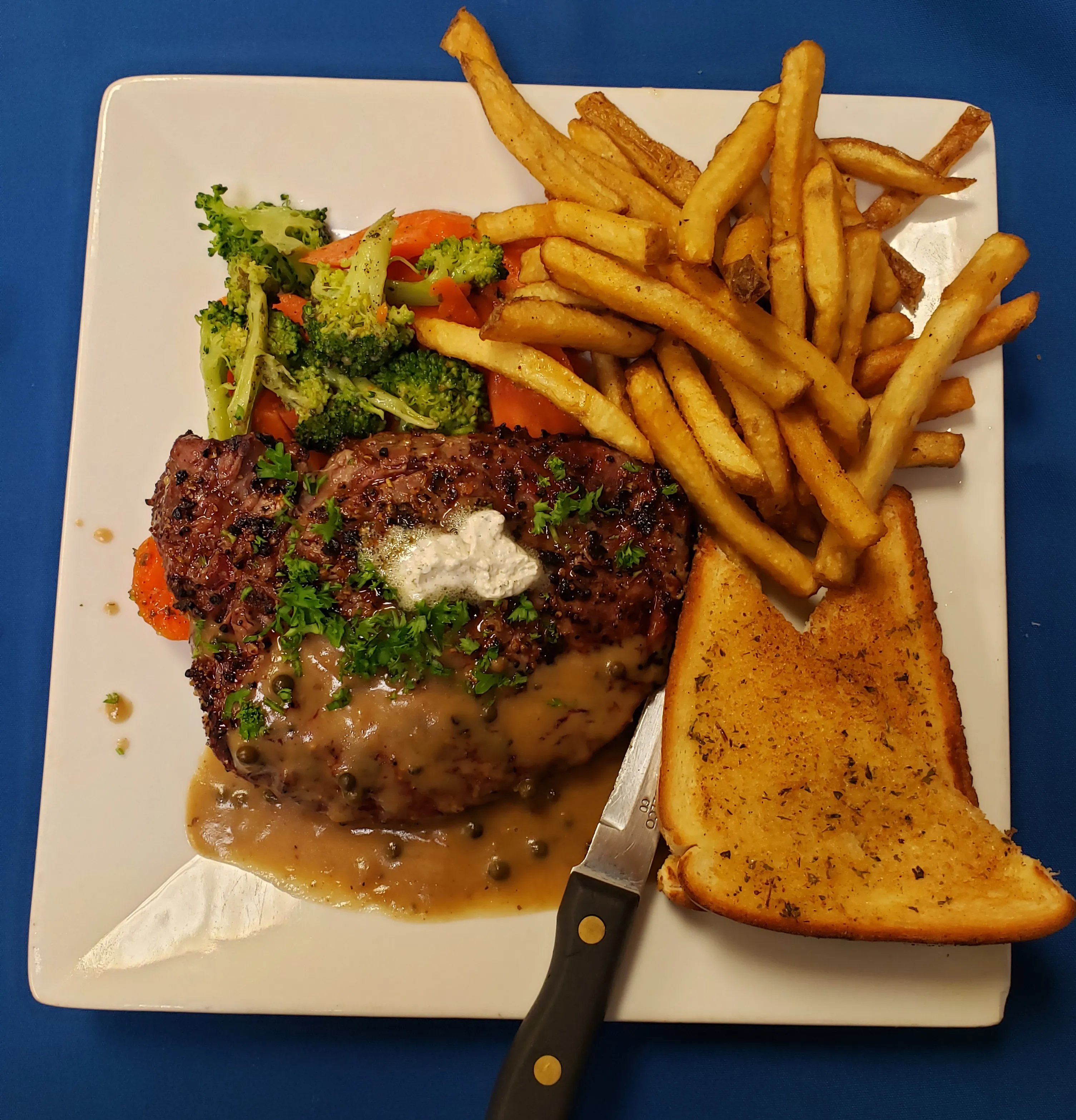 Char-grilled rib eye steak with fries and vegetables at Cheryl's Country Kitchen in Airdrie, AB