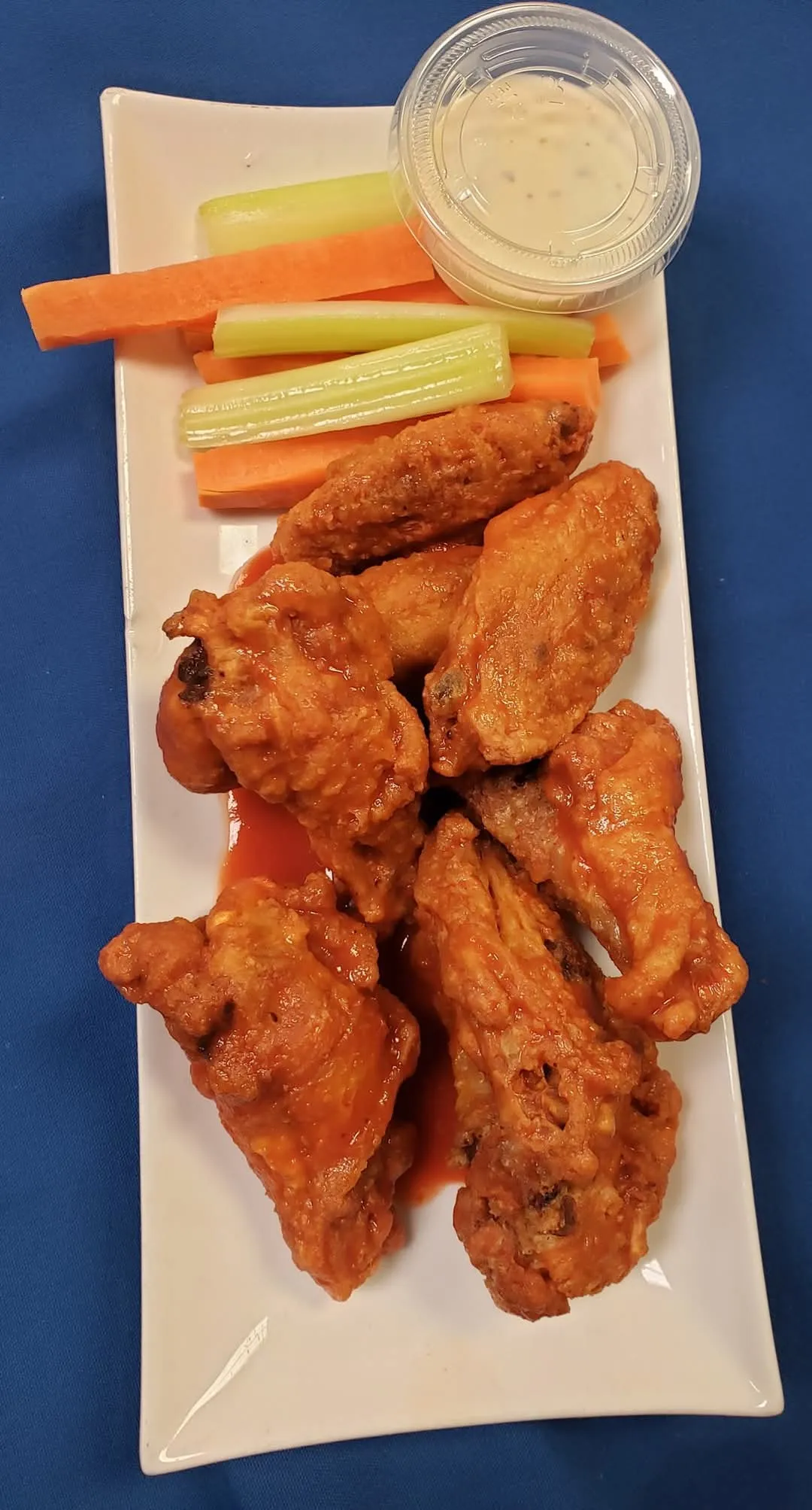 Saucy chicken wings with celery, carrots and ranch dip at Cheryl's Country Kitchen in Airdrie, AB